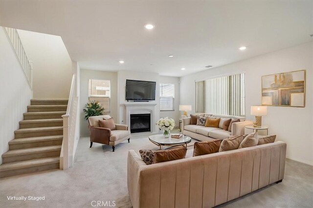 4852 S Jordan Ave, Ontario, CA 91762 - living area featuring light colored carpet, stairway, recessed lighting, and a glass covered fireplace