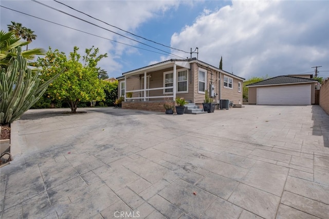 10404 Jardine Ave, Sunland, CA 91040 - manufactured / mobile home with an outbuilding, a garage, and central air condition unit