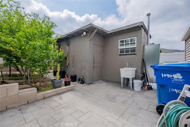 10404 Jardine Ave, Sunland, CA 91040 - view of property exterior featuring stucco siding, a patio area, and a sink