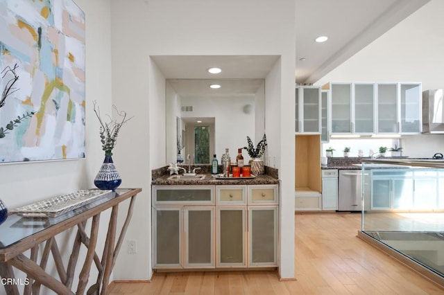 1196 Montecito Dr, Los Angeles, CA 90031 - kitchen featuring dishwasher, wall chimney exhaust hood, light wood-style flooring, glass insert cabinets, and recessed lighting