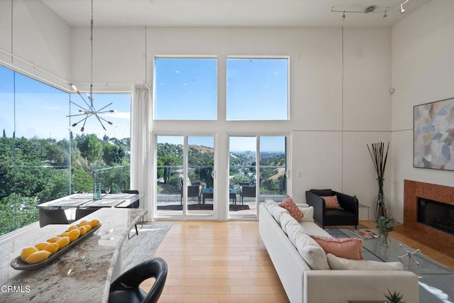 1196 Montecito Dr, Los Angeles, CA 90031 - living room with plenty of natural light, a premium fireplace, light wood finished floors, a chandelier, and a high ceiling