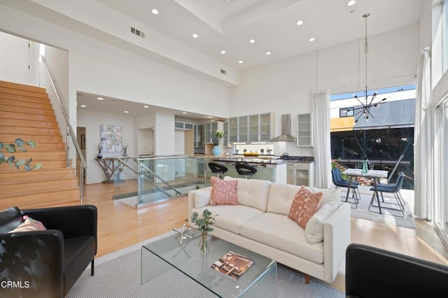 1196 Montecito Dr, Los Angeles, CA 90031 - living area featuring a high ceiling, light wood finished floors, recessed lighting, and stairs