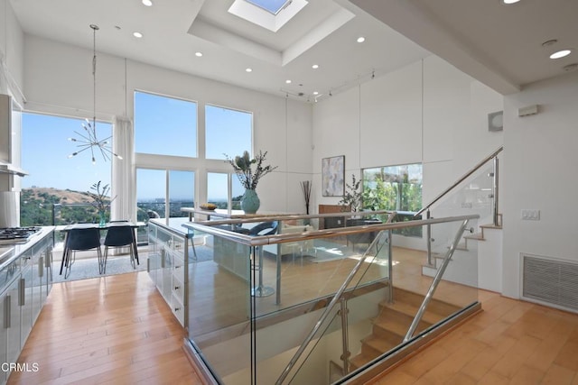 1196 Montecito Dr, Los Angeles, CA 90031 - kitchen with a towering ceiling, light wood-type flooring, modern cabinets, white cabinetry, and recessed lighting