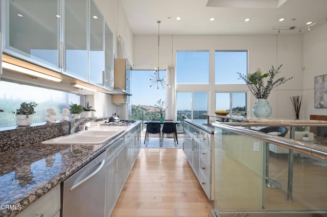 1196 Montecito Dr, Los Angeles, CA 90031 - kitchen with a sink, appliances with stainless steel finishes, recessed lighting, light wood finished floors, and dark stone counters