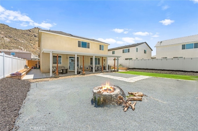 27241 Toro Vista St, Menifee, CA 92585 - rear view of property with a fire pit, a patio area, solar panels, and a fenced backyard