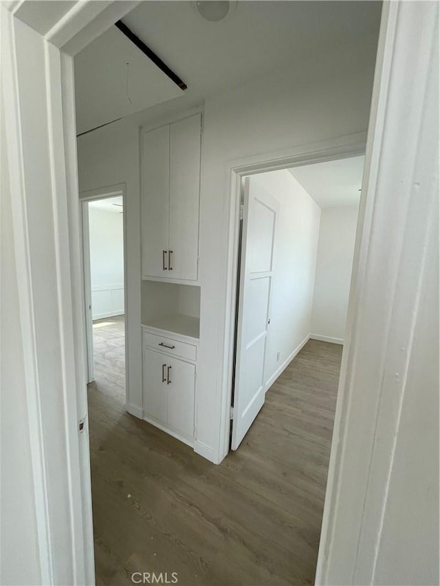 6663 Sage Ave Unit 29, Palms, CA 92277 - hallway featuring wood finished floors and baseboards