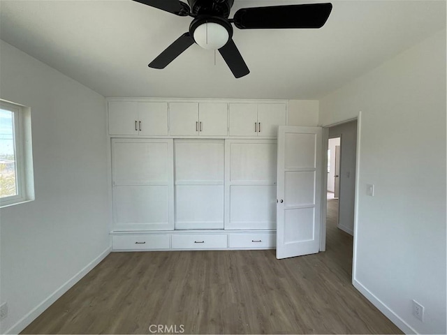 6663 Sage Ave Unit 29, Palms, CA 92277 - unfurnished bedroom with baseboards, wood finished floors, and ceiling fan