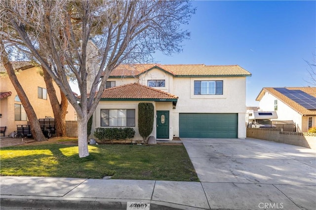 43007 Pearlwood Dr, Lancaster, CA 93536 - mediterranean / spanish house featuring a tile roof, a garage, stucco siding, and concrete driveway