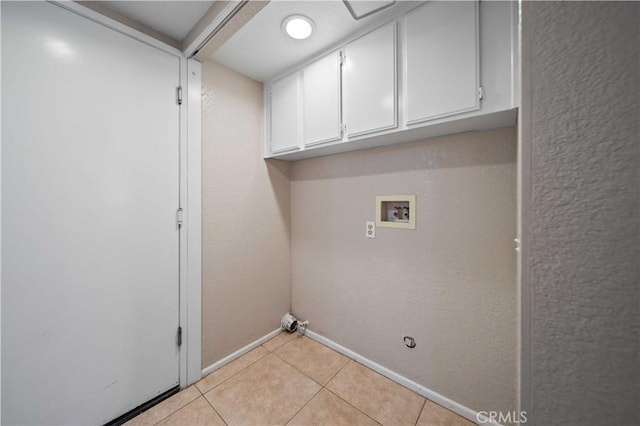 43007 Pearlwood Dr, Lancaster, CA 93536 - laundry area with cabinet space, hookup for a washing machine, light tile patterned floors, baseboards, and gas dryer hookup