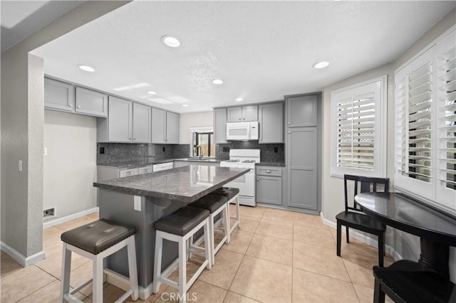 43007 Pearlwood Dr, Lancaster, CA 93536 - kitchen featuring white appliances, gray cabinets, a sink, decorative backsplash, and recessed lighting