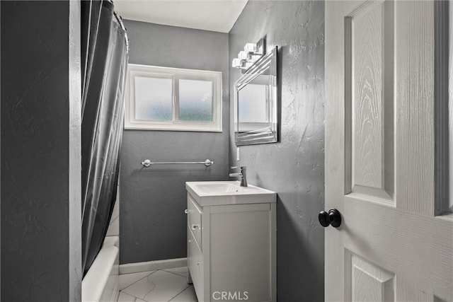 417 Jefferson St, Willows, CA 95988 - bathroom featuring vanity, marble look tiles, shower / bathtub combination with curtain, and baseboards