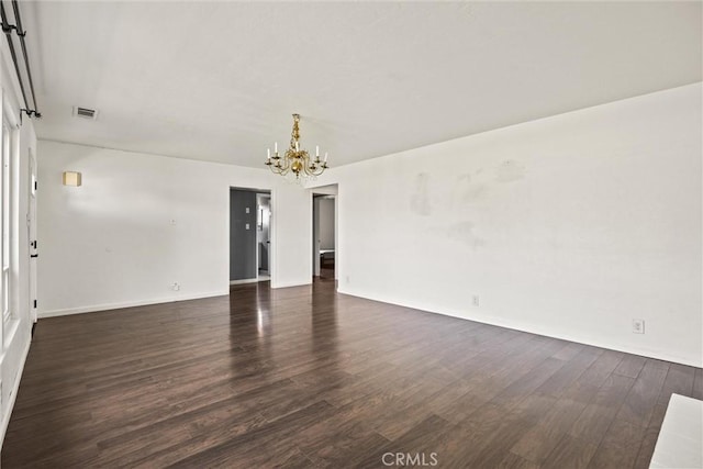 417 Jefferson St, Willows, CA 95988 - empty room featuring a chandelier, dark wood-style flooring, and baseboards