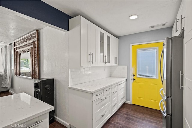 417 Jefferson St, Willows, CA 95988 - kitchen with freestanding refrigerator, white cabinetry, light stone countertops, dark wood finished floors, and glass insert cabinets