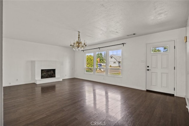 417 Jefferson St, Willows, CA 95988 - unfurnished living room with plenty of natural light, dark wood-style flooring, a chandelier, and baseboards