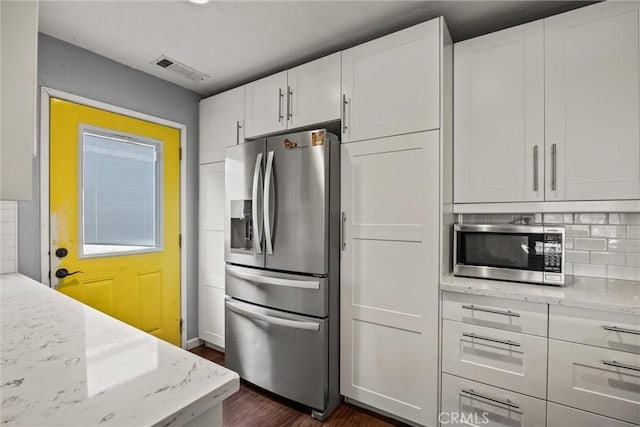 417 Jefferson St, Willows, CA 95988 - kitchen featuring stainless steel appliances, dark wood-style flooring, white cabinets, and light stone countertops