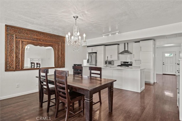 417 Jefferson St, Willows, CA 95988 - dining space featuring a chandelier, baseboards, dark wood finished floors, and a textured ceiling