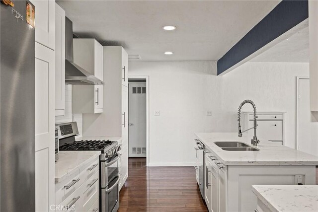 417 Jefferson St, Willows, CA 95988 - kitchen with appliances with stainless steel finishes, a sink, wall chimney range hood, dark wood-style flooring, and an island with sink