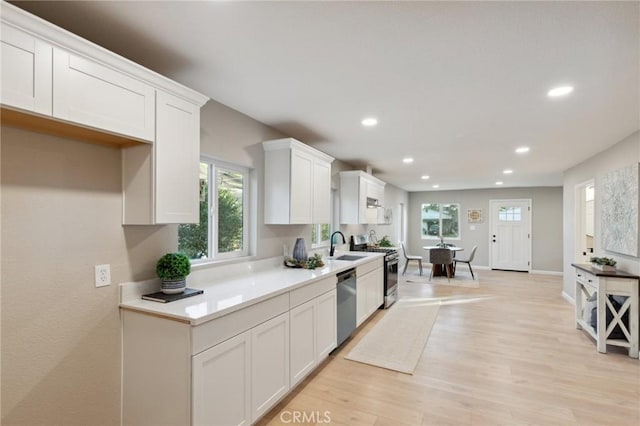 325 N 3rd Ave, Oakdale, CA 95361 - kitchen featuring stainless steel appliances, plenty of natural light, white cabinetry, light wood-type flooring, and recessed lighting