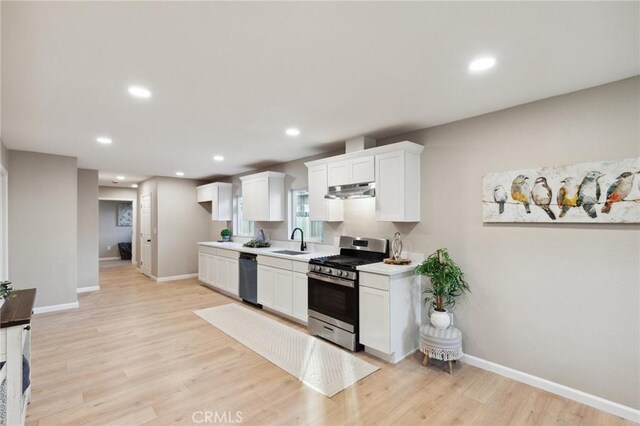 325 N 3rd Ave, Oakdale, CA 95361 - kitchen with stainless steel range with gas cooktop, a sink, dishwashing machine, light countertops, and baseboards