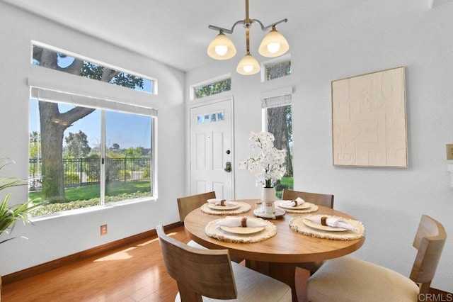 7254 Shoreline Dr Unit 131, San Diego, CA 92122 - dining area with wood finished floors, baseboards, and a towering ceiling