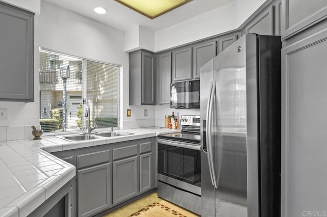 7254 Shoreline Dr Unit 131, San Diego, CA 92122 - kitchen featuring appliances with stainless steel finishes, a sink, gray cabinets, tile countertops, and recessed lighting
