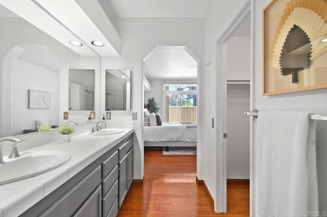 7254 Shoreline Dr Unit 131, San Diego, CA 92122 - full bathroom featuring double vanity, wood finished floors, ensuite bath, and recessed lighting