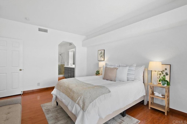7254 Shoreline Dr Unit 131, San Diego, CA 92122 - bedroom with arched walkways, wood finished floors, and baseboards