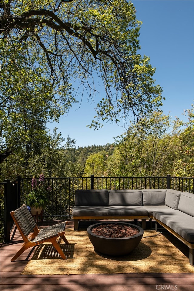 27663 N Bay Rd, Lake Arrowhead, CA 92352 - deck with an outdoor living space with a fire pit and a view of trees