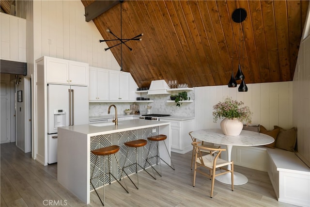 27663 N Bay Rd, Lake Arrowhead, CA 92352 - kitchen with high end white refrigerator, open shelves, a sink, light countertops, and wood ceiling
