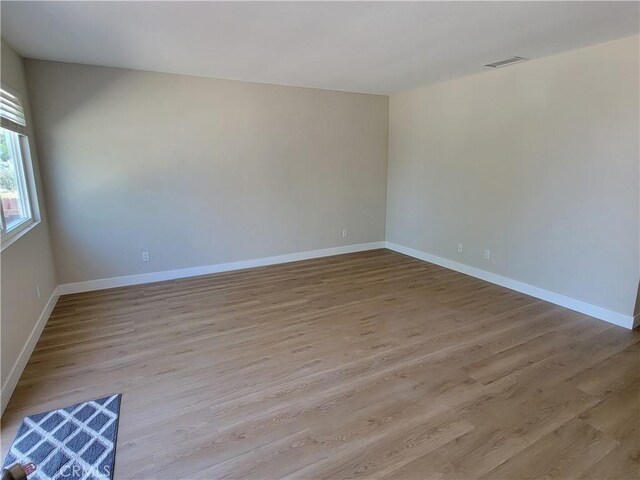 15475 Shadow Mountain Ln, Lake Elsinore, CA 92530 - unfurnished room featuring baseboards and wood finished floors