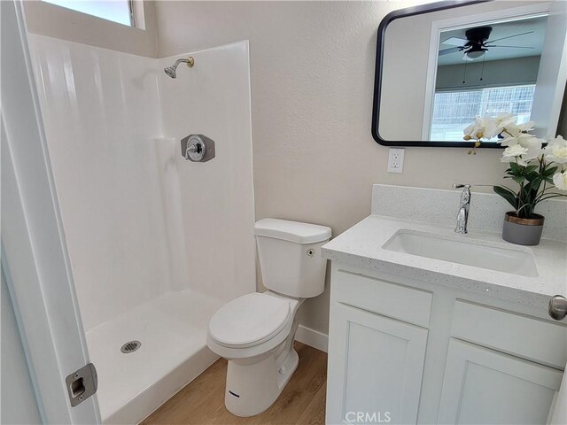 15475 Shadow Mountain Ln, Lake Elsinore, CA 92530 - full bath with vanity, a shower, a ceiling fan, and wood finished floors