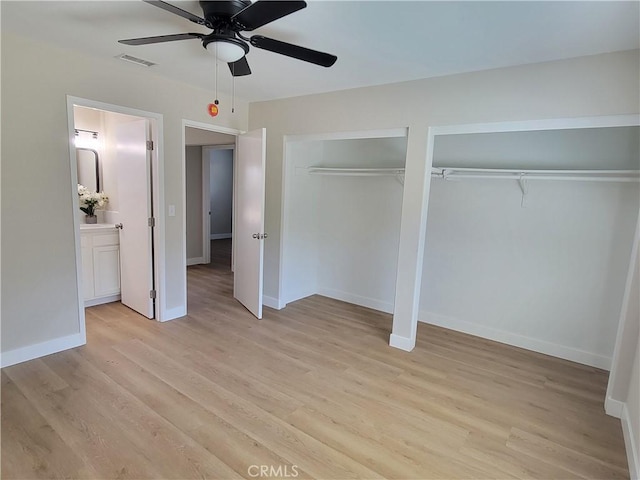 15475 Shadow Mountain Ln, Lake Elsinore, CA 92530 - unfurnished bedroom with multiple closets, light wood-style flooring, and ceiling fan