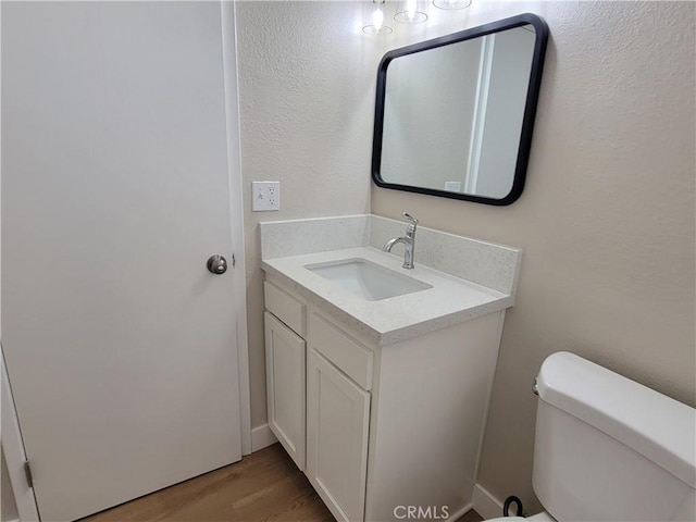 15475 Shadow Mountain Ln, Lake Elsinore, CA 92530 - half bathroom featuring vanity and wood finished floors