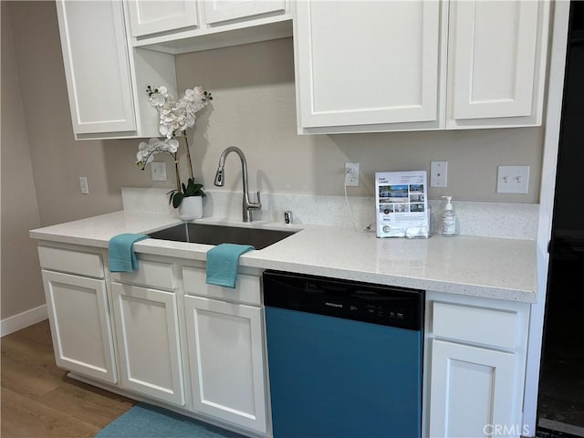 15475 Shadow Mountain Ln, Lake Elsinore, CA 92530 - kitchen featuring dishwashing machine, white cabinetry, wood finished floors, and light stone counters