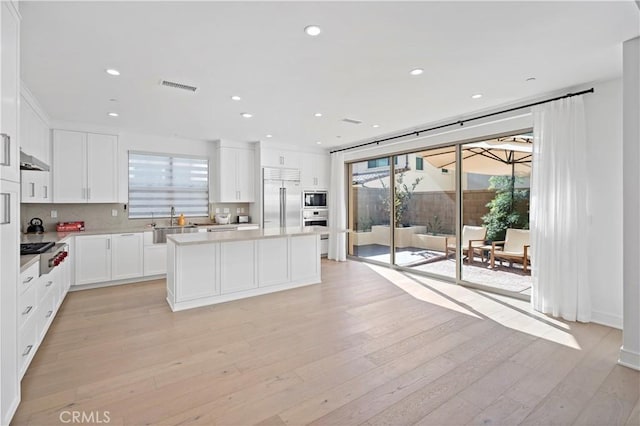 113 Imagination Trl, Irvine, CA 92620 - kitchen with built in appliances, healthy amount of natural light, a center island, a sink, and recessed lighting