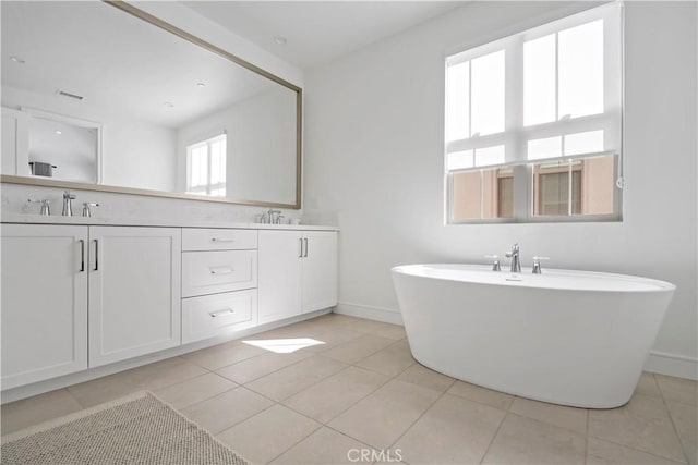 113 Imagination Trl, Irvine, CA 92620 - bathroom with double vanity, a soaking tub, tile patterned floors, and baseboards