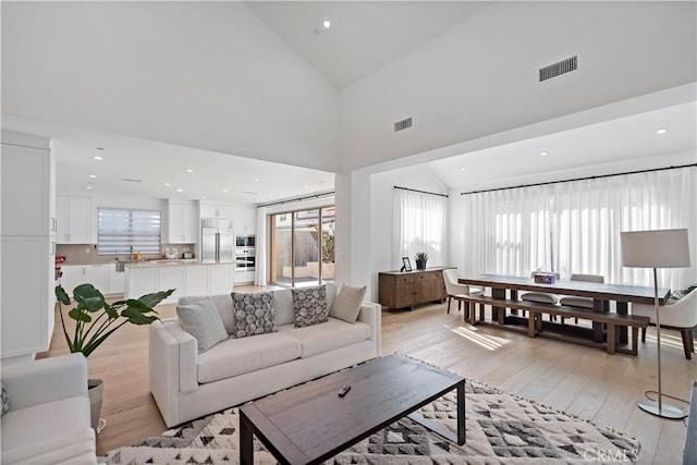 113 Imagination Trl, Irvine, CA 92620 - living room with vaulted ceiling, light wood-style floors, and recessed lighting
