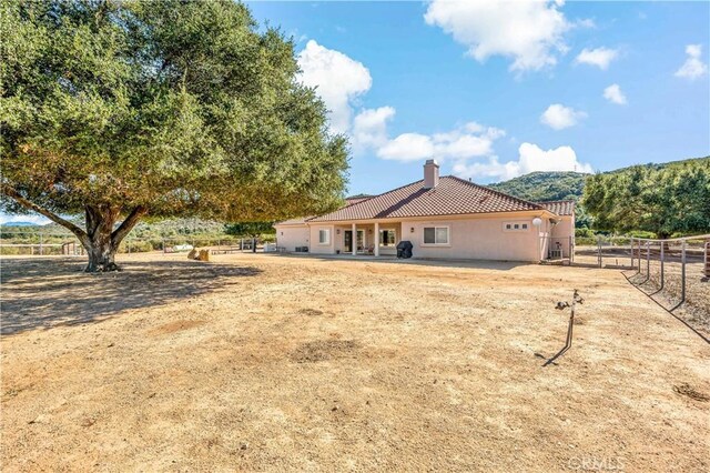 10204 Mount Olympus Valley Rd, Fallbrook, CA 92028 - rear view of property featuring a chimney, a tiled roof, and stucco siding
