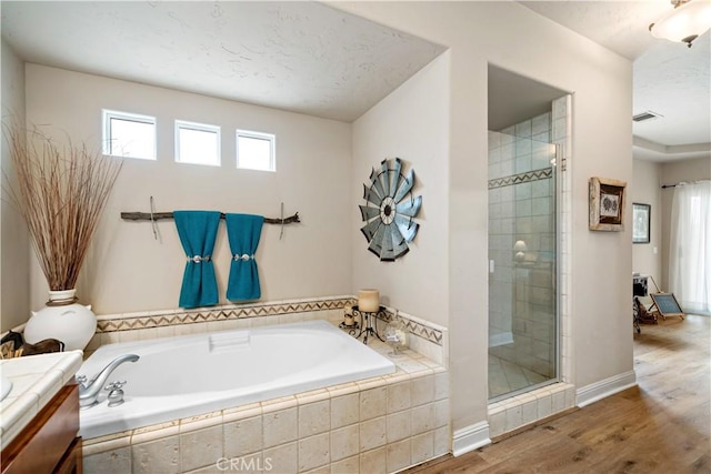 10204 Mount Olympus Valley Rd, Fallbrook, CA 92028 - bathroom featuring a garden tub, a stall shower, vanity, wood finished floors, and baseboards