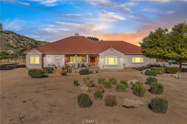 10204 Mount Olympus Valley Rd, Fallbrook, CA 92028 - mediterranean / spanish-style house featuring a tile roof, a chimney, covered porch, and stucco siding