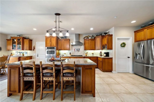 10204 Mount Olympus Valley Rd, Fallbrook, CA 92028 - kitchen featuring appliances with stainless steel finishes, wall chimney exhaust hood, brown cabinetry, and recessed lighting