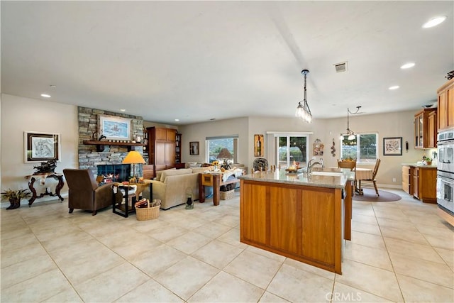 10204 Mount Olympus Valley Rd, Fallbrook, CA 92028 - living area featuring light tile patterned floors, recessed lighting, plenty of natural light, and a stone fireplace
