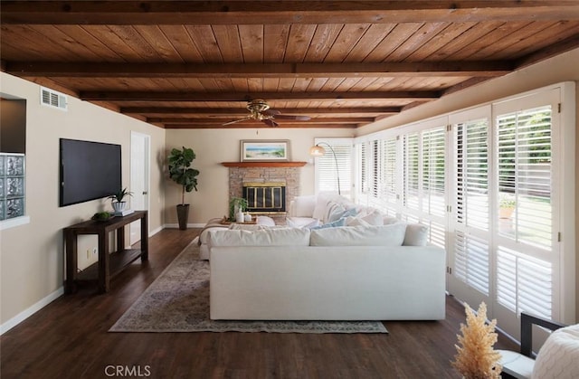 5941 E Valley Forge Dr, Orange, CA 92869 - living room featuring ceiling fan, baseboards, a stone fireplace, wood ceiling with exposed beams, and dark wood-type flooring