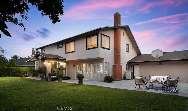 5941 E Valley Forge Dr, Orange, CA 92869 - rear view of house featuring a patio area, outdoor lounge area, stucco siding, a chimney, and a yard