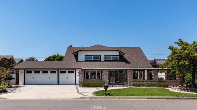 5941 E Valley Forge Dr, Orange, CA 92869 - view of front of house with a garage, concrete driveway, a porch, a front lawn, and a chimney
