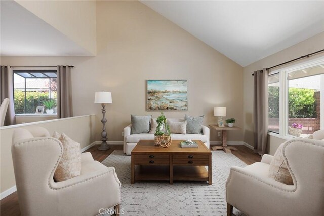 5941 E Valley Forge Dr, Orange, CA 92869 - living room featuring baseboards, light wood-type flooring, and high vaulted ceiling