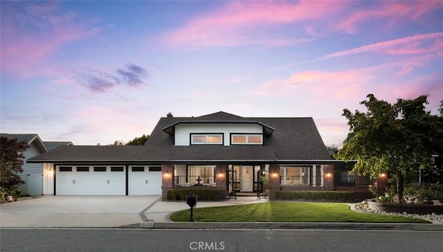 5941 E Valley Forge Dr, Orange, CA 92869 - view of front of home featuring concrete driveway, an attached garage, and a front lawn