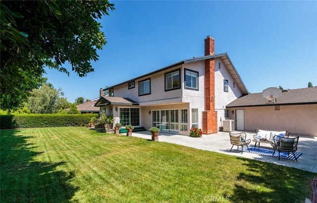 5941 E Valley Forge Dr, Orange, CA 92869 - rear view of house with a patio area, outdoor lounge area, a chimney, stucco siding, and a lawn
