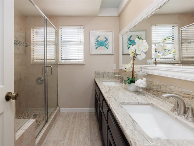 5941 E Valley Forge Dr, Orange, CA 92869 - full bathroom featuring a shower stall, double vanity, wood finished floors, and baseboards