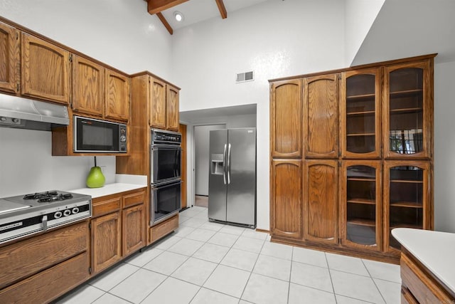 2125 Prospect St, National City, CA 91950 - kitchen with black appliances, under cabinet range hood, high vaulted ceiling, brown cabinets, and beam ceiling